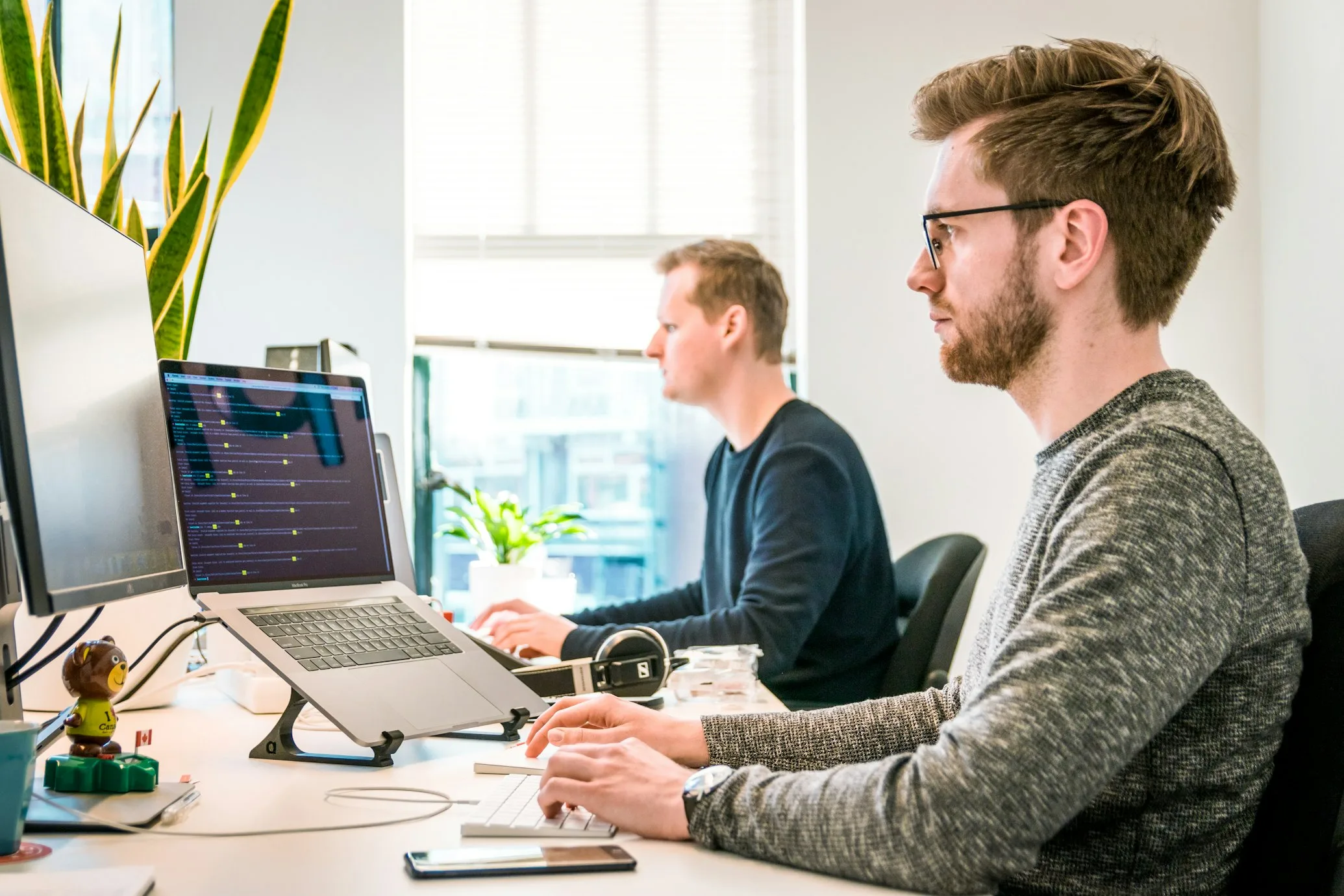 FactualMinds AWS architects reviewing cloud cost dashboard and architecture diagrams